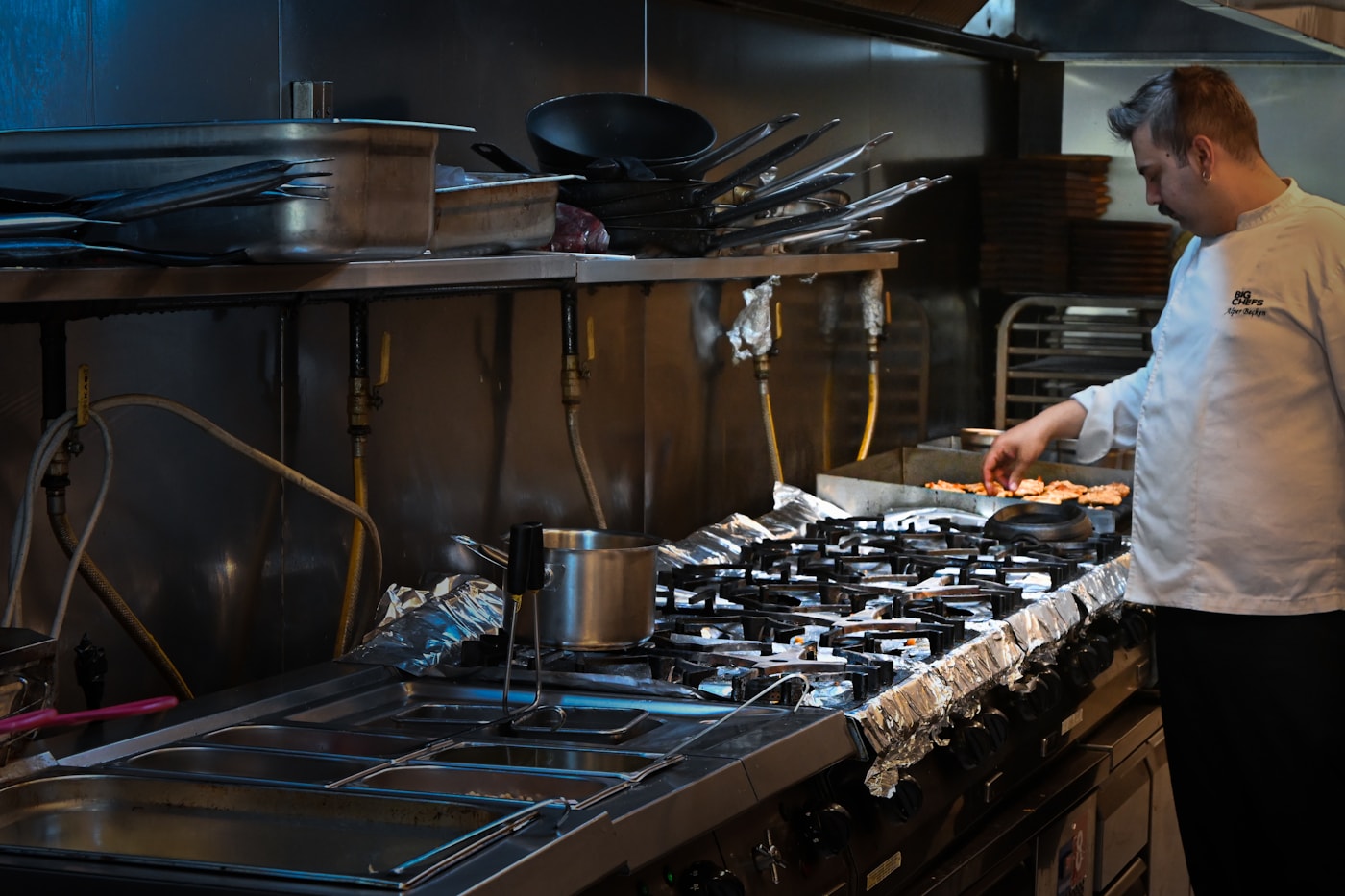 Professional chef using commercial kitchen equipment